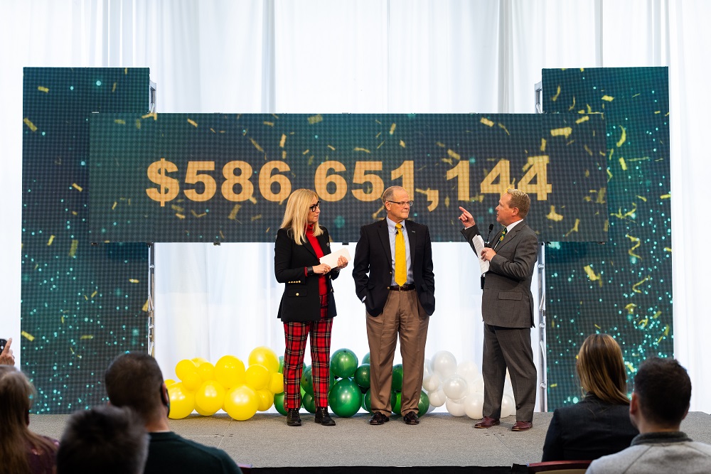 Photo: The final total for the In Our Hands campaign, with John Glover, President Bresciani, and Kristi Hanson discussing the campaign's impact